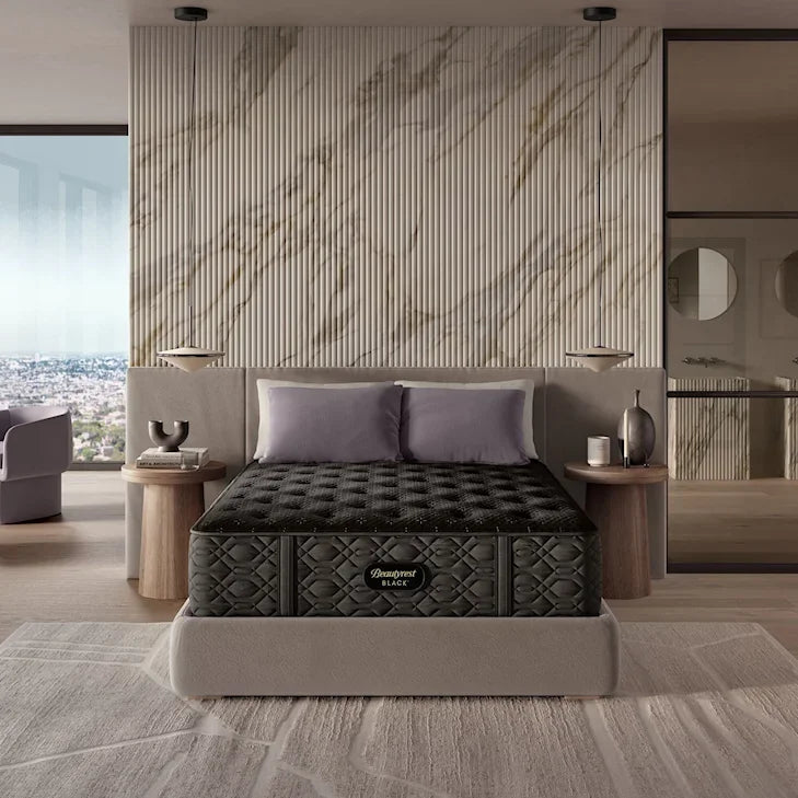Black mattress on a bed in a modern bedroom with marble wall and city view.