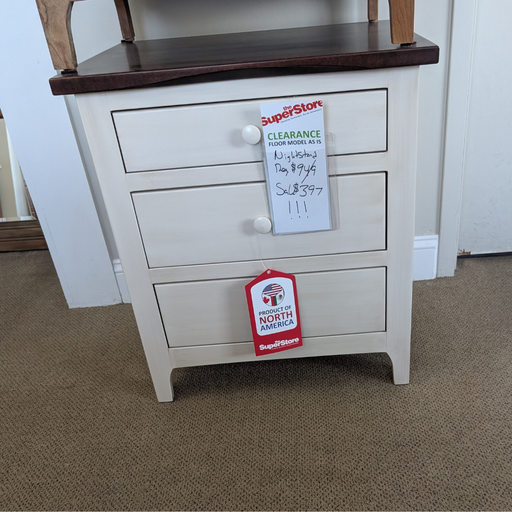 White nightstand with wooden top and Superstore tags on a carpeted floor.