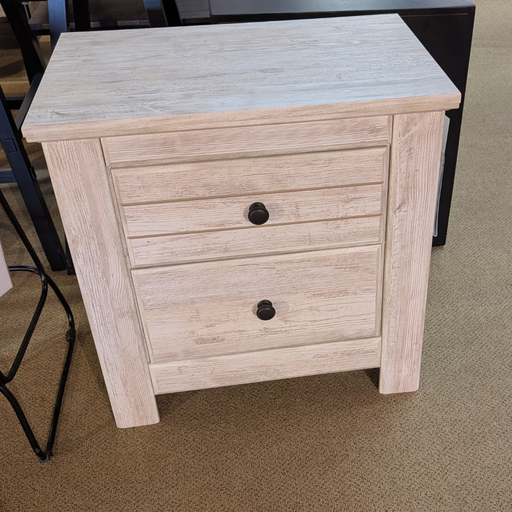 Wooden nightstand with two drawers on a carpeted floor