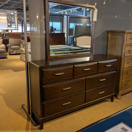 Wooden dresser with mirror in a furniture store setting