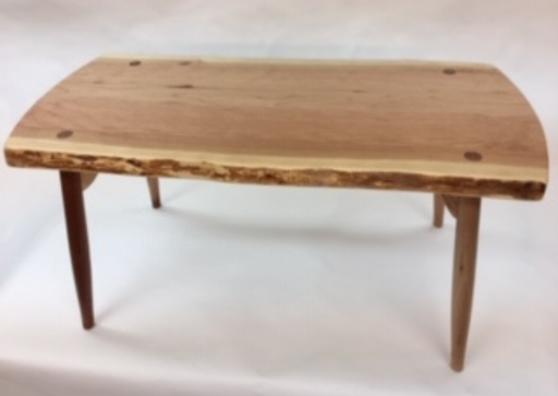 Wooden coffee table with a natural finish on a white background