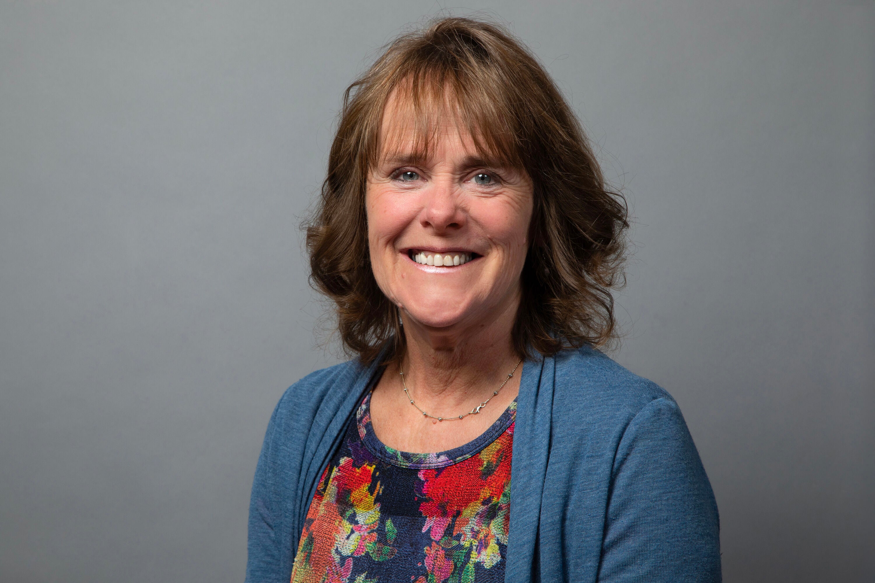 Shows image of designer Natali with nature backdrop.