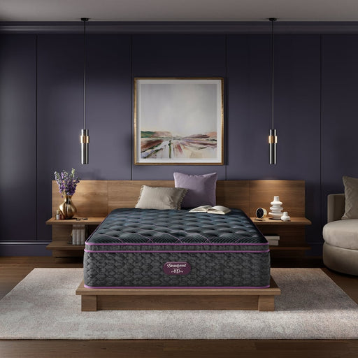 Bedroom with a full front view of a plush, pillow-top mattress made by BeautyRest